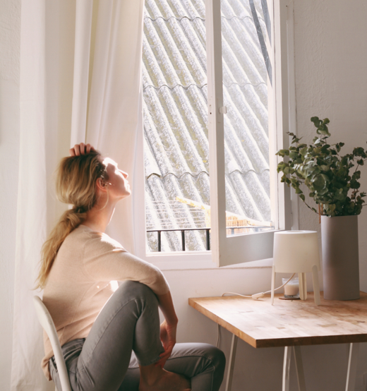 Woman Looking outside a window